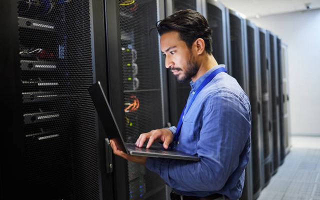IT engineer reviewing server infrastructure in a data centre