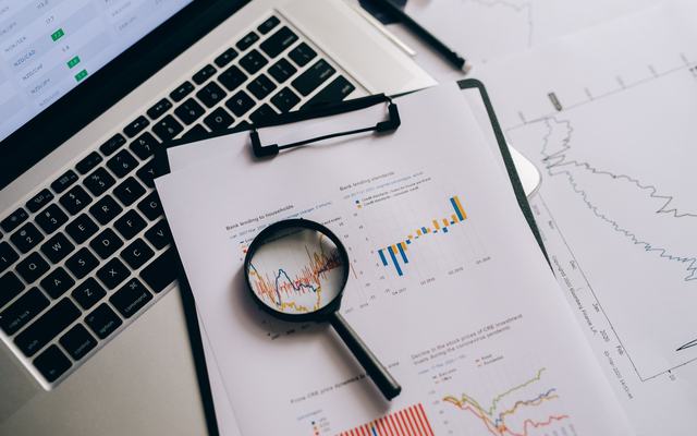 Technology due diligence financial analysis with magnifying glass