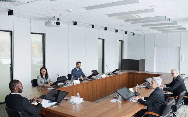 Executive board meeting around a boardroom table